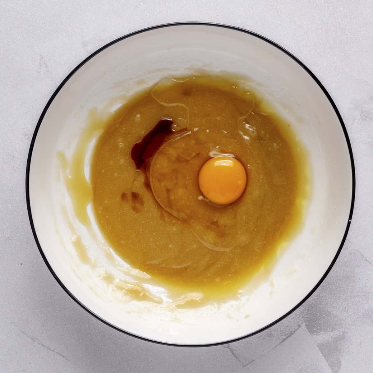 After whisking together with egg and vanilla added.