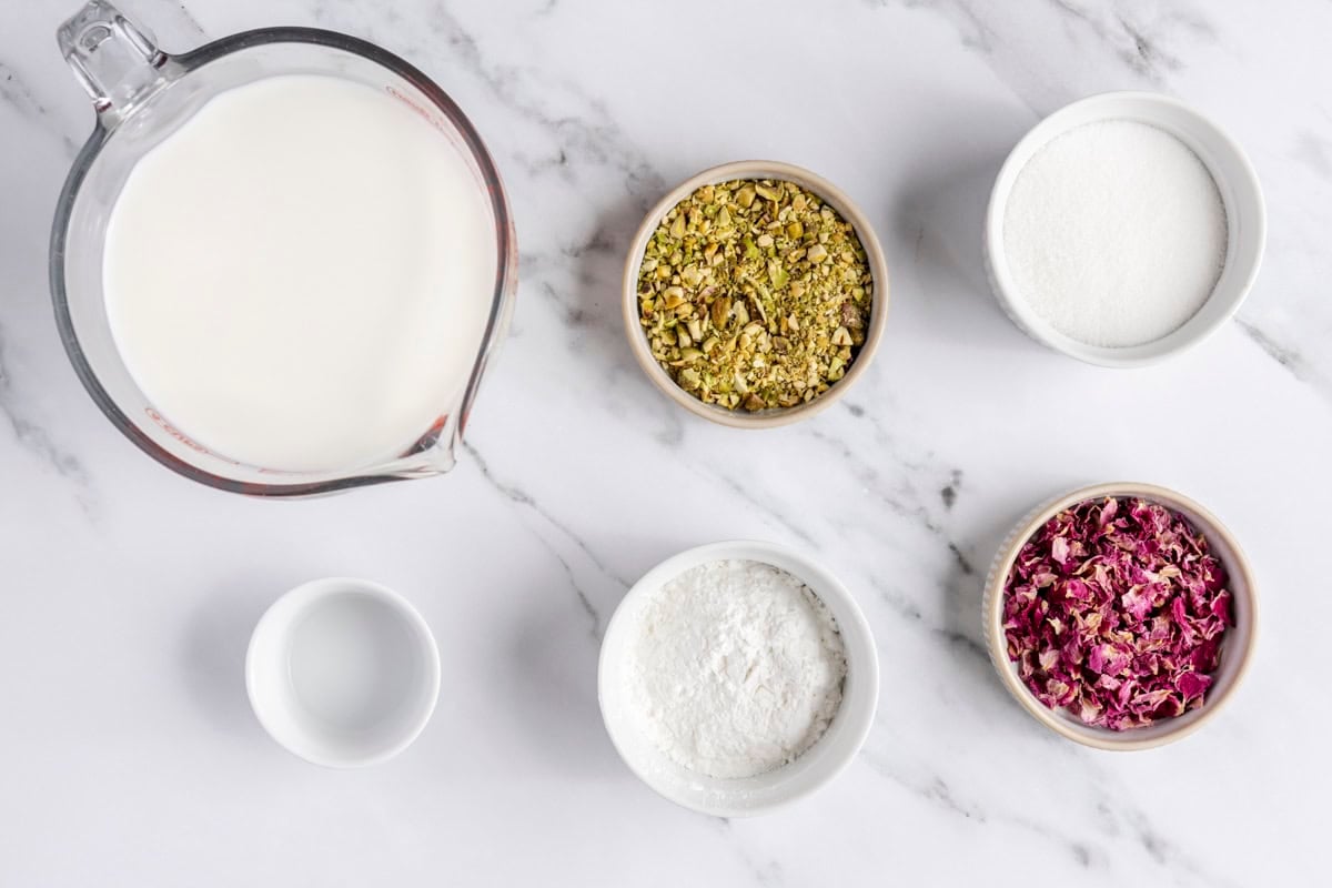 Ingredients for recipe: milk, sugar, rose water, cornstarch, sugar, pistachios and rose petals.