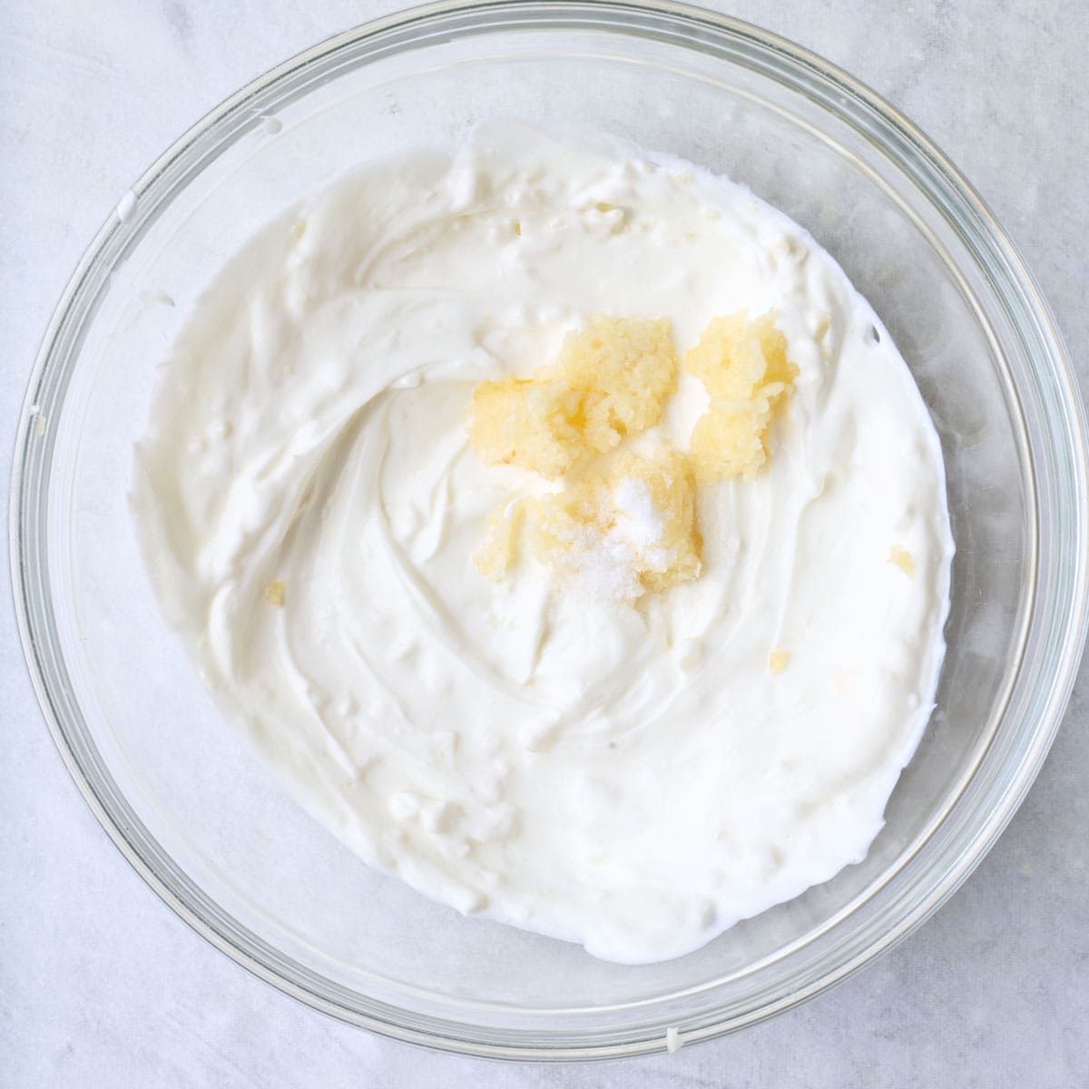 Yogurt, garlic, and salt in a bowl.