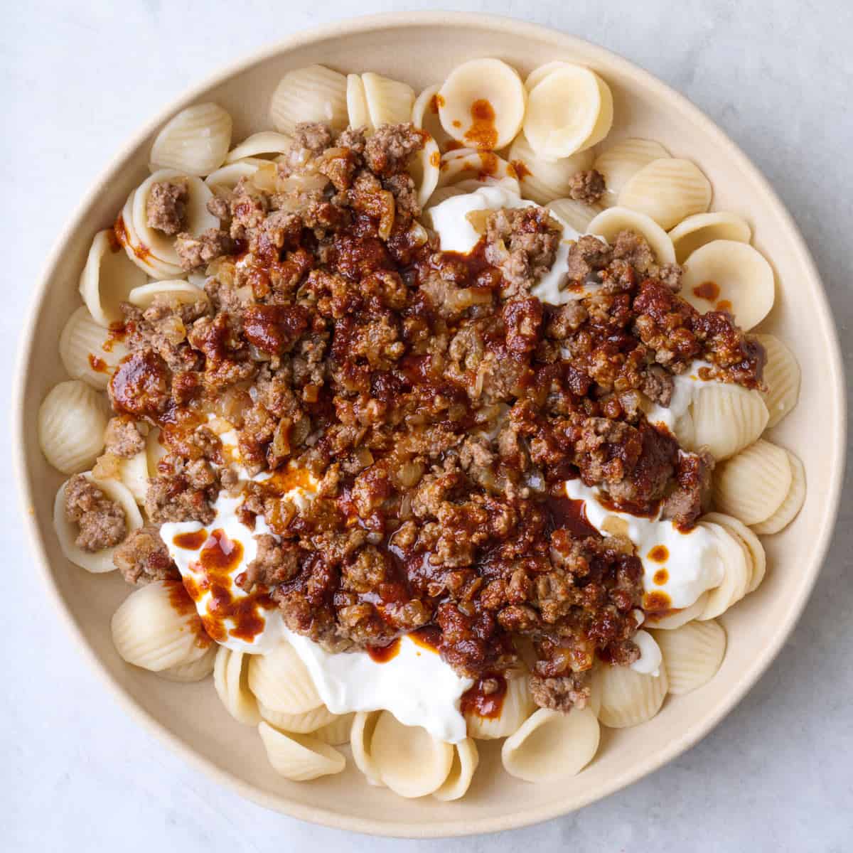 Paprika butter sauce drizzled on top of beef and pasta.