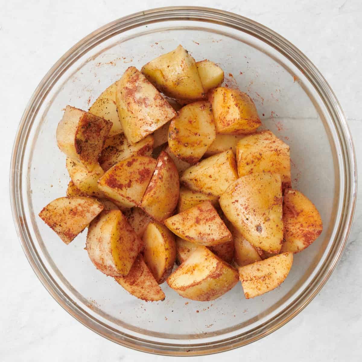 After tossing cubed potatoes with oil and seasonings to fully coat.