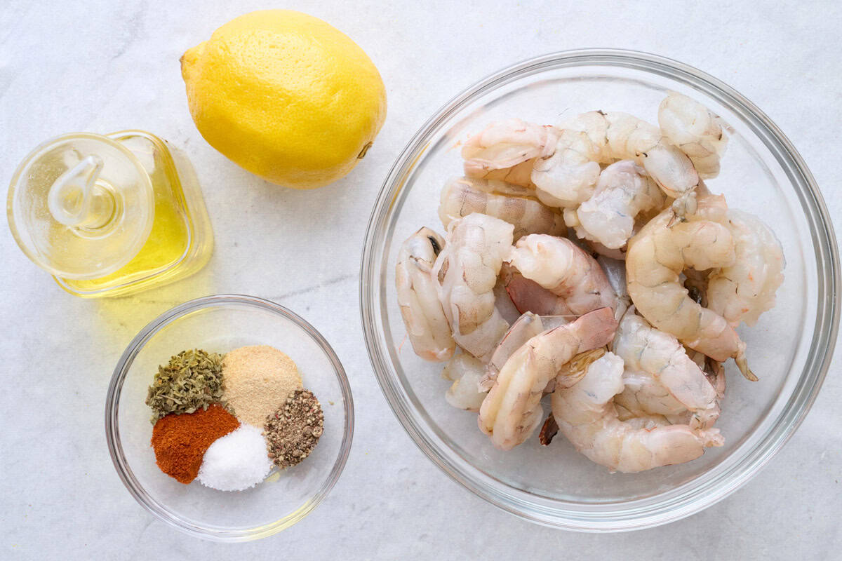 Ingredients for recipe: peeled jump shrimp, seasoning blend, oil, and lemon.
