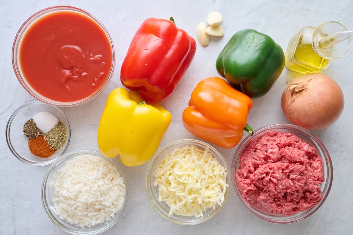 Ingredients for recipe: tomato sauce, spices, cooked rice, bell peppers, garlic, oil, onion, ground beef and shredded mozzarella.