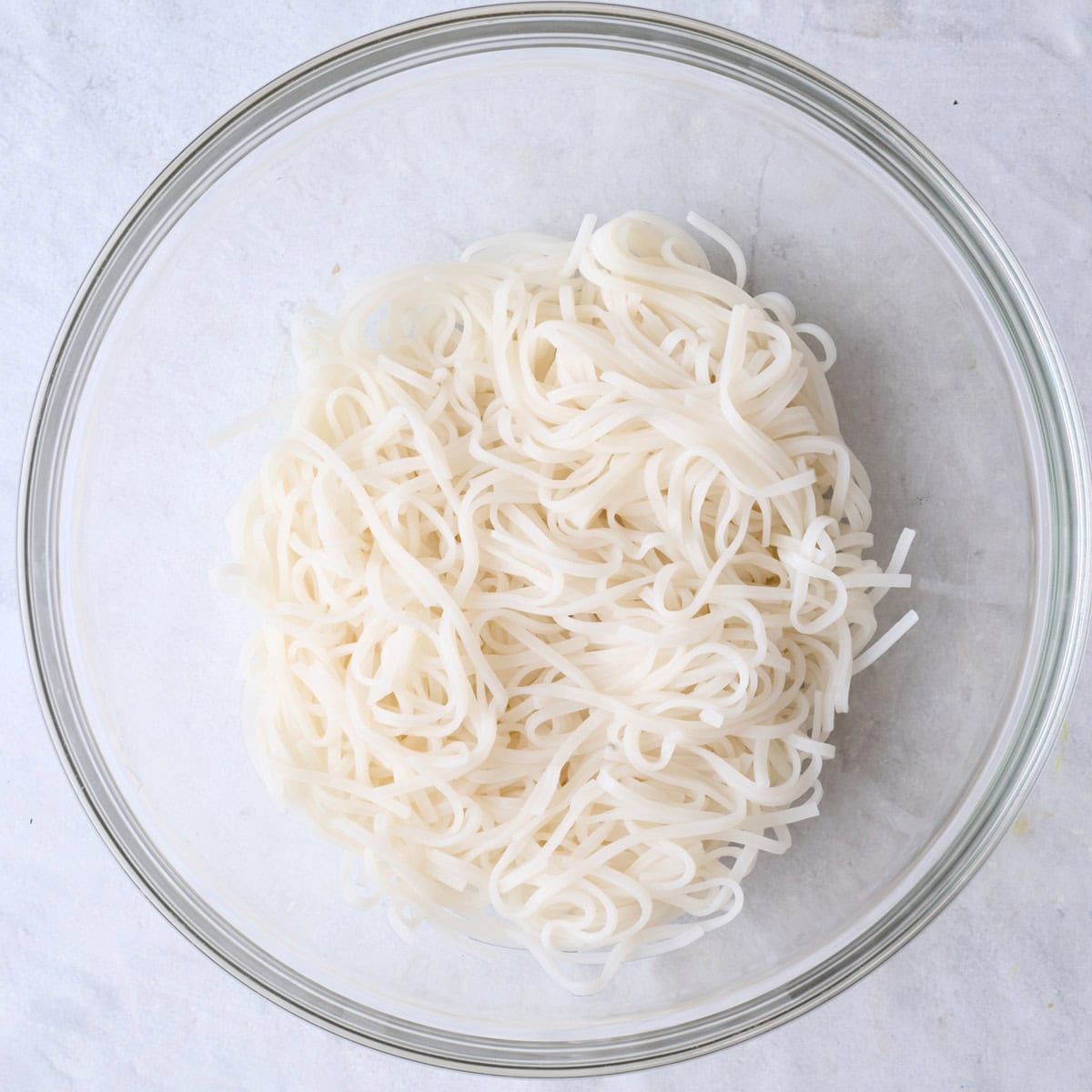 Cooked rice noodles in a bowl.