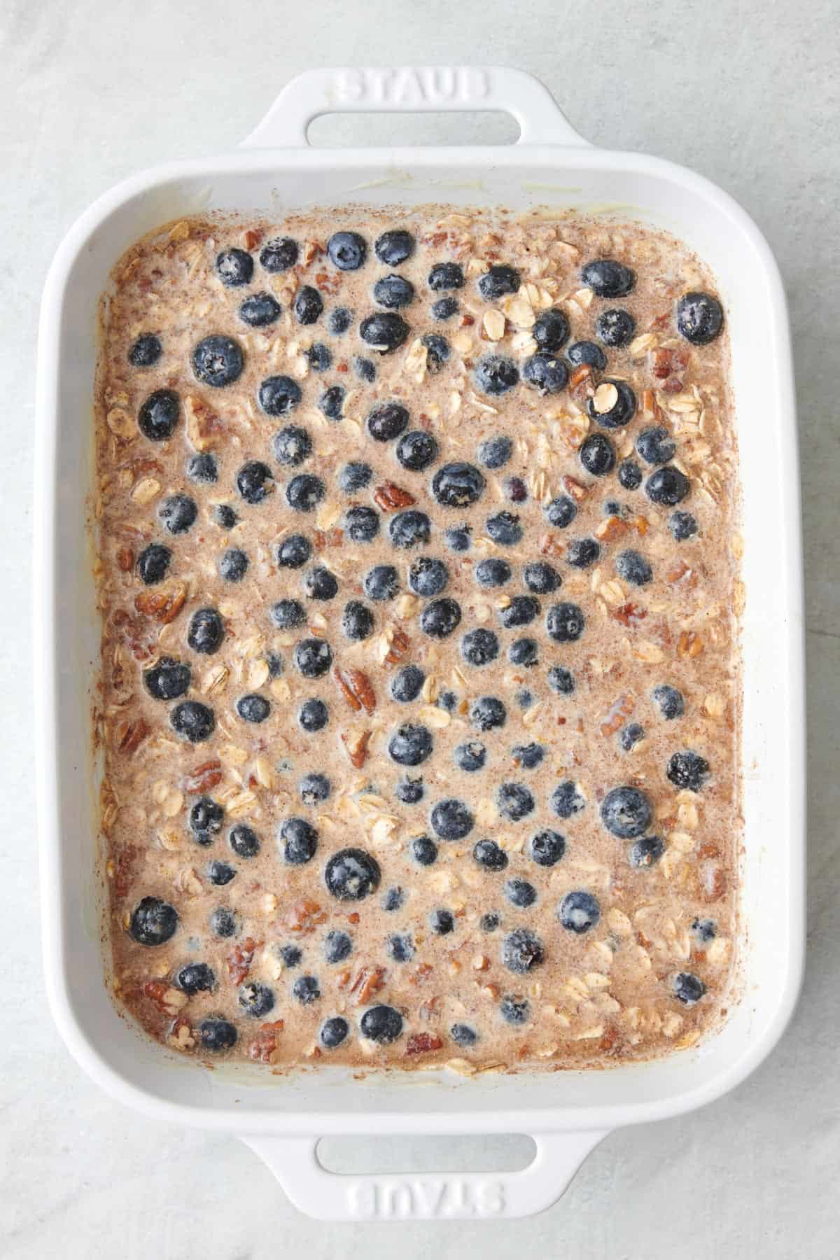 Blueberries added to baking dish before baking.