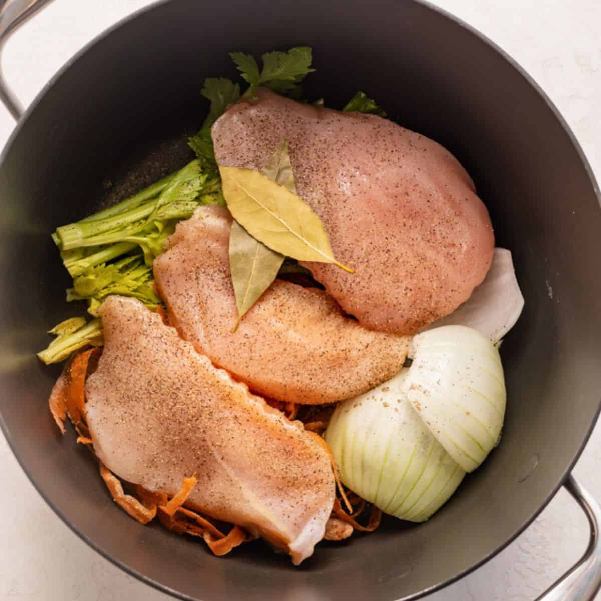 Chicken and seasonings added to pot.