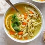 Shredded chicken added top soup and served in bowl.