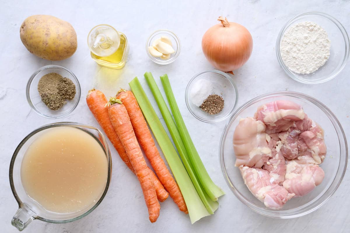 Ingredients for recipe: potato, seasoning, broth, oil, carrots, celery, onion, garlic, flour, and boneless skinless chicken thighs.