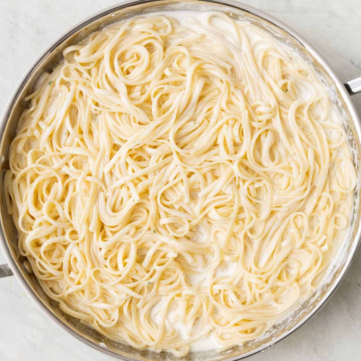 After tossing pasta and sauce together in pan.
