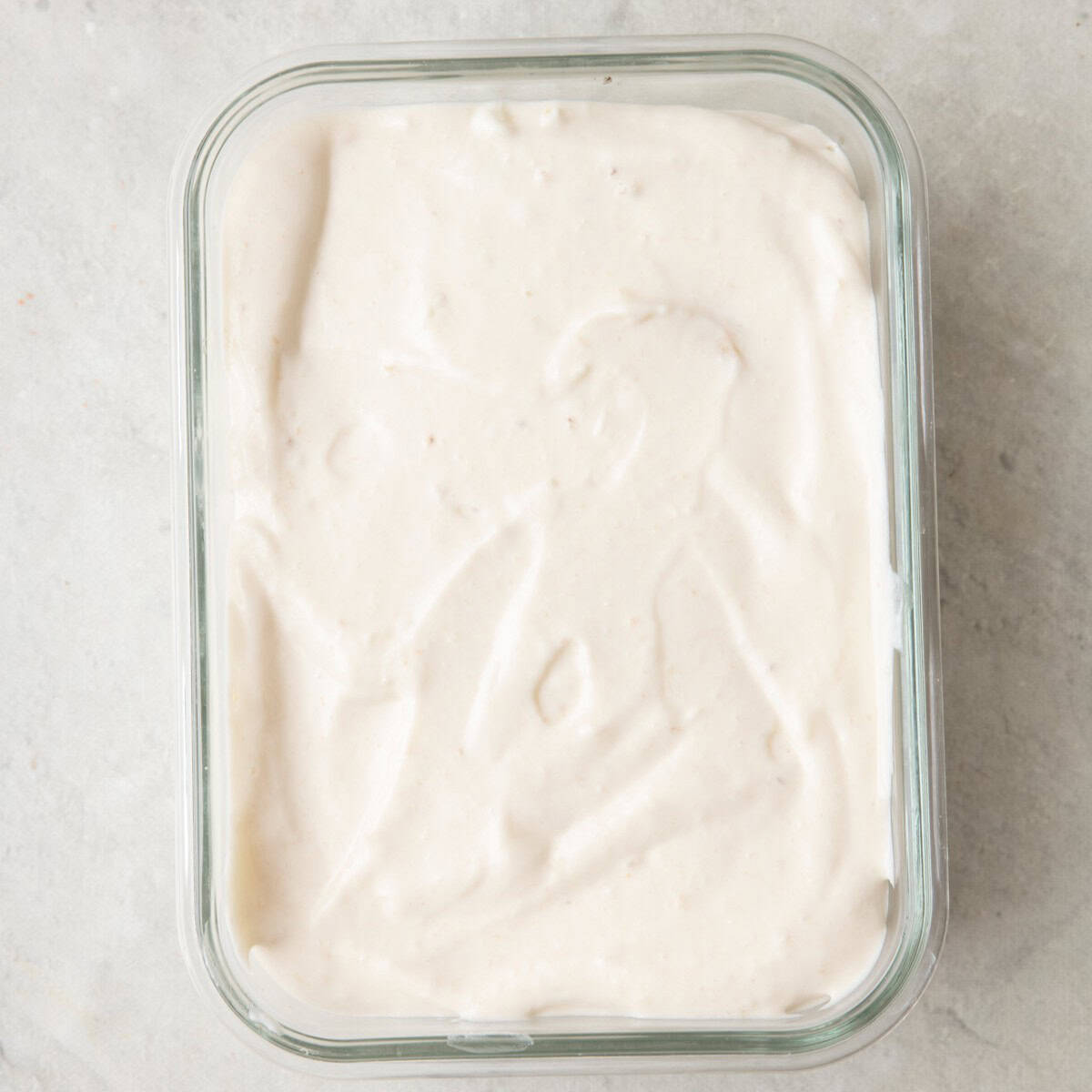 Banana cream mixture added to a small glass dish before freezing.