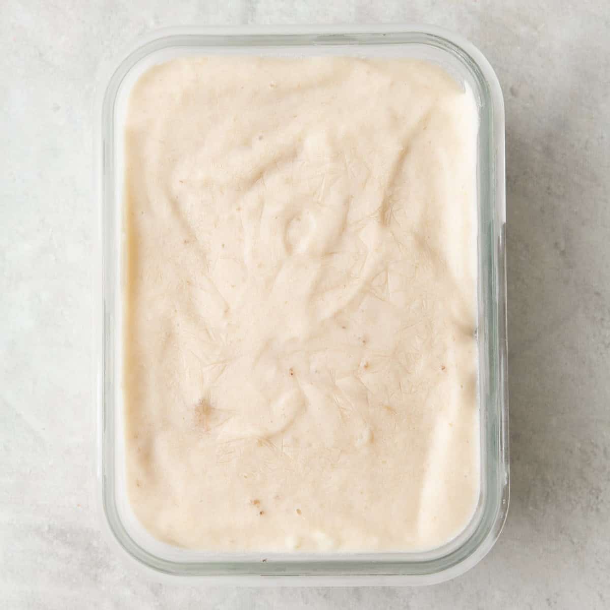 Banana cream mixture added to a small glass dish after freezing.