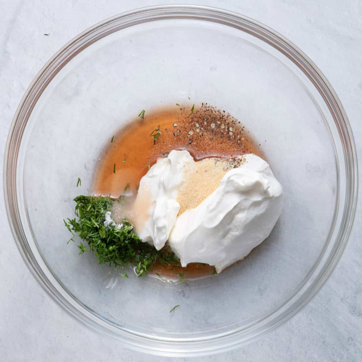 Dressing ingredients in a bowl before combining.