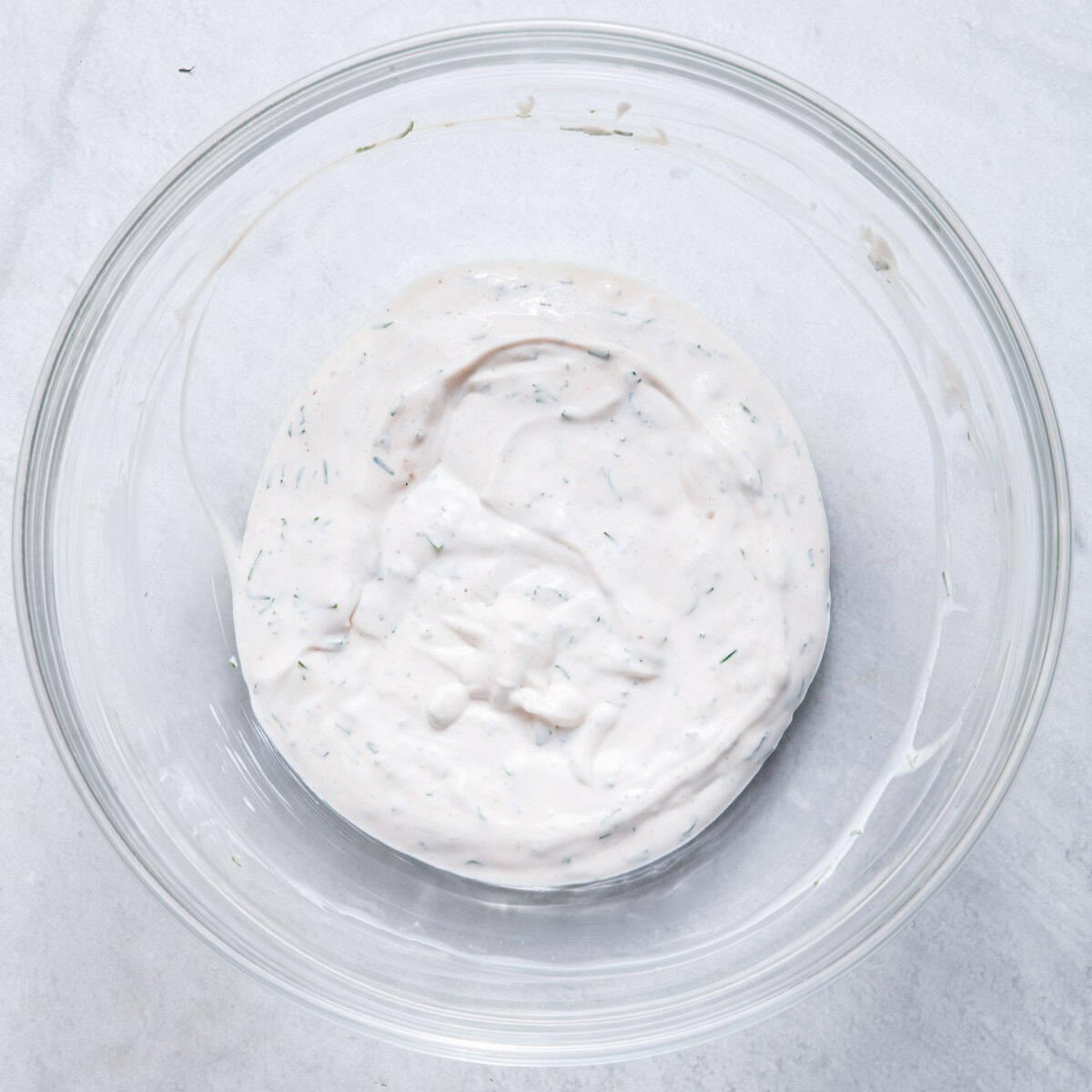 Creamy dressing after mixing in a bowl.,