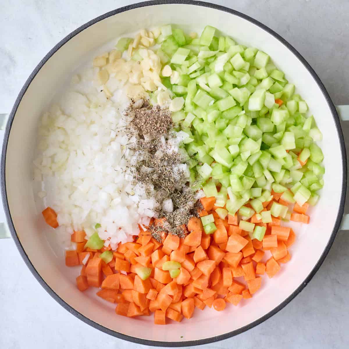 Onions, carrots, celery, garlic, thyme, salt and pepper in a pot with melted butter.