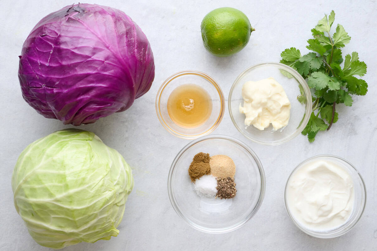Red cabbage, green cabbage, honey, lime, mayo, yogurt, seasonings, and cilantro.