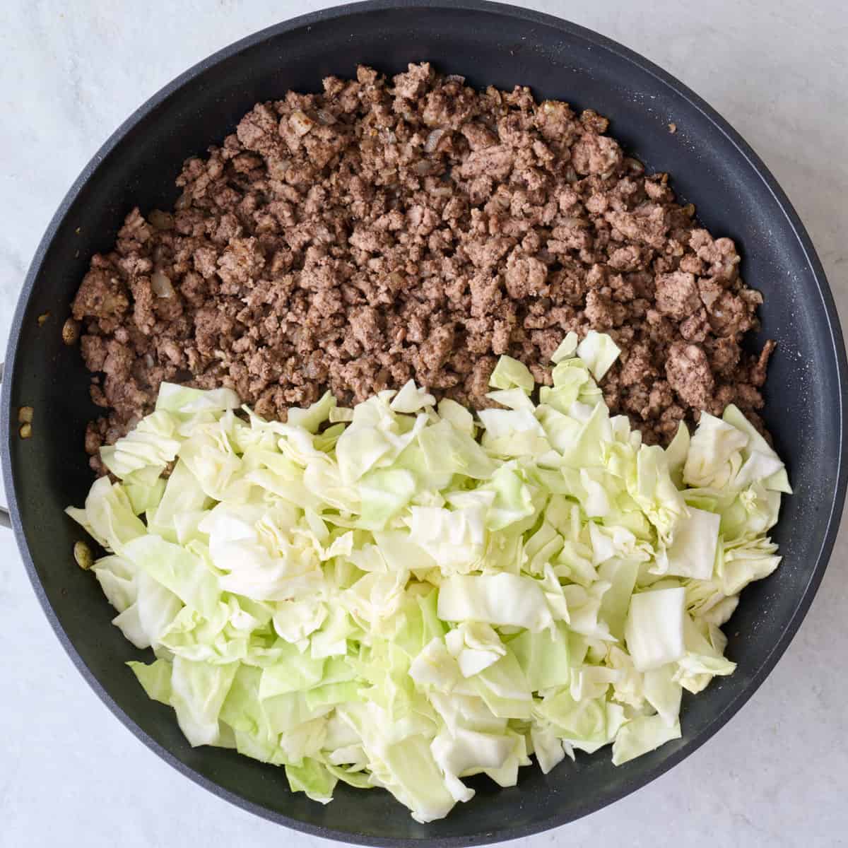 Chopped cabbaged added to spiced beef.