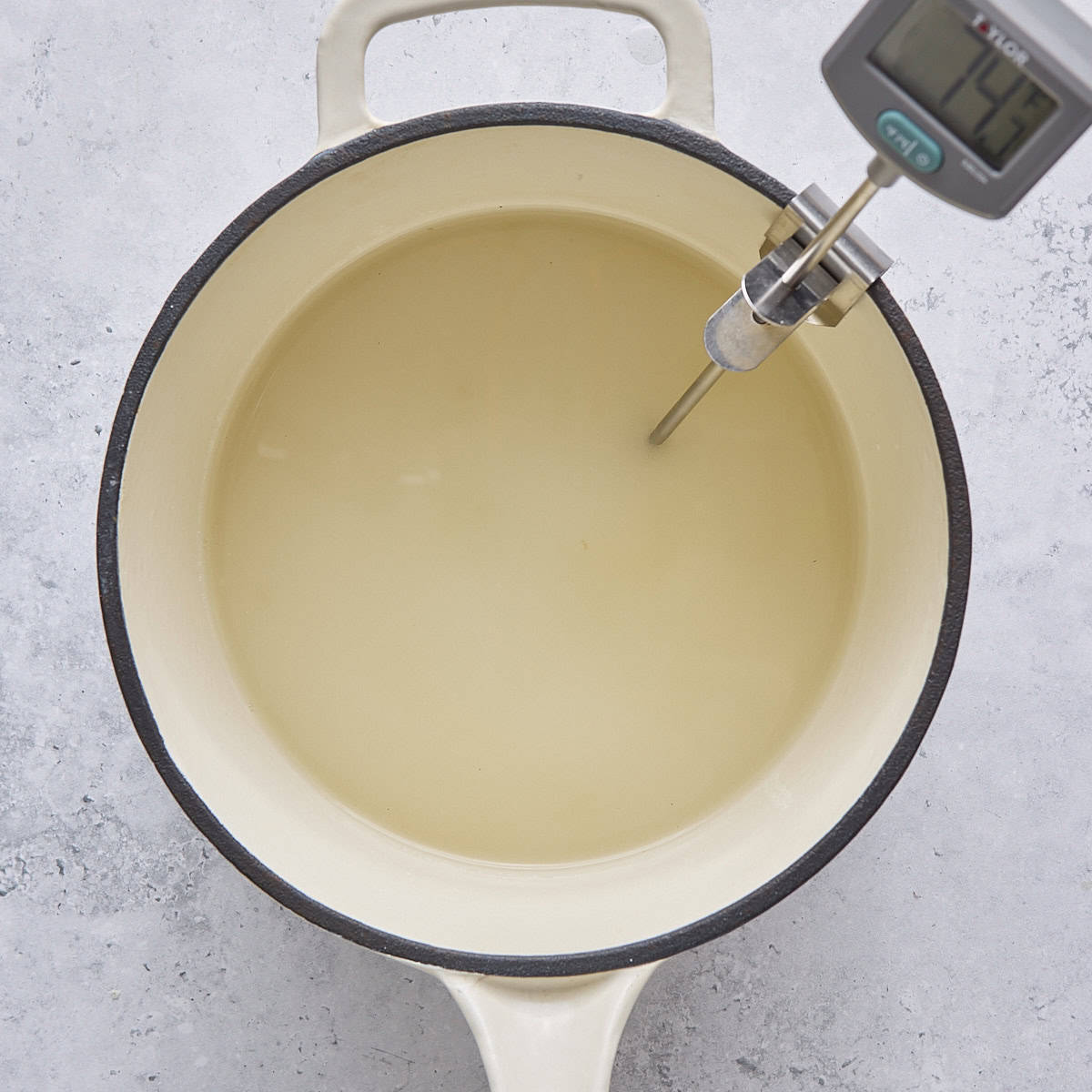 Sugar and water in a saucepan with candy thermometer.