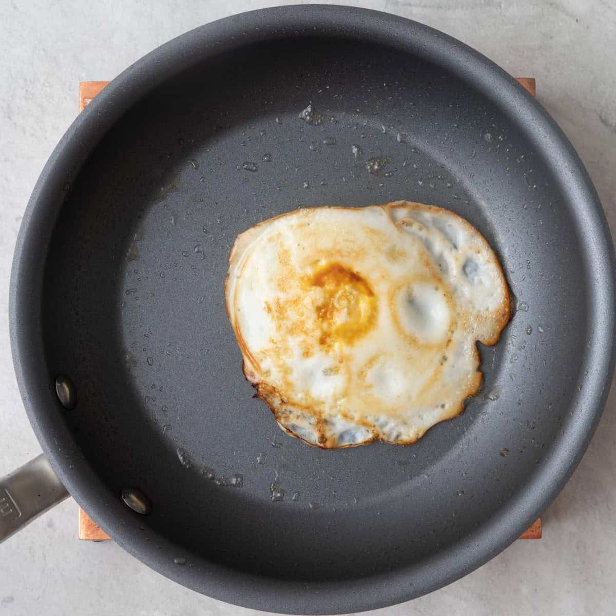 Over hard egg in skillet.