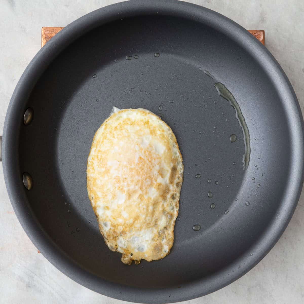 Over easy egg in skillet.