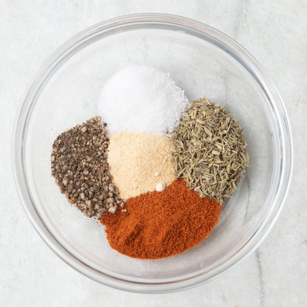 Thyme, paprika, garlic powder, salt and pepper in a small bowl before combining.