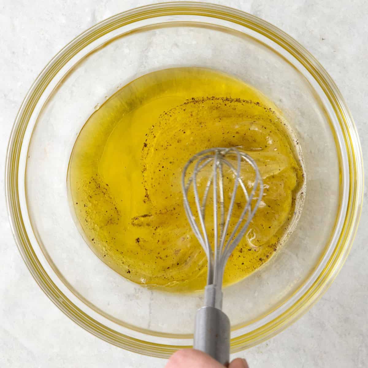 Whisking dressing in bowl.