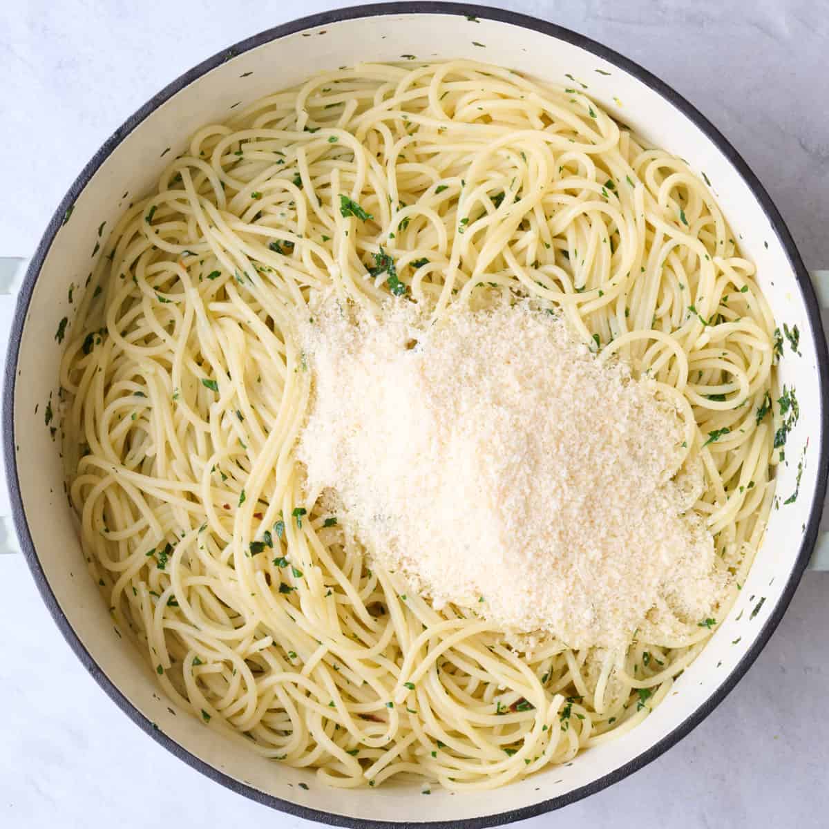 Parmesan cheese added on top of pasta.