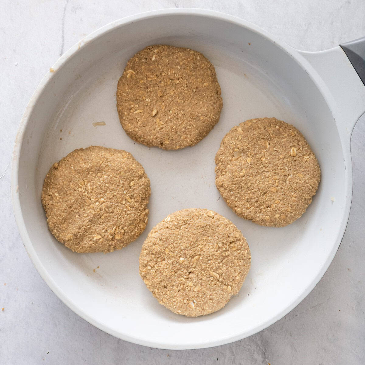 Mushroom lentil patties in a skillet.