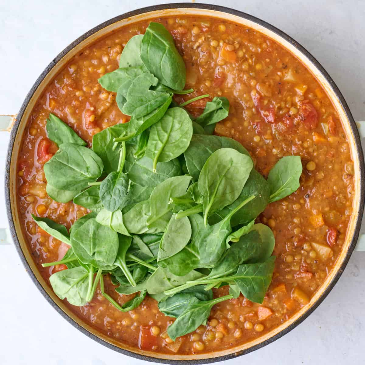 After stirring together partially blended soup into a creamy consistency with spinach added.