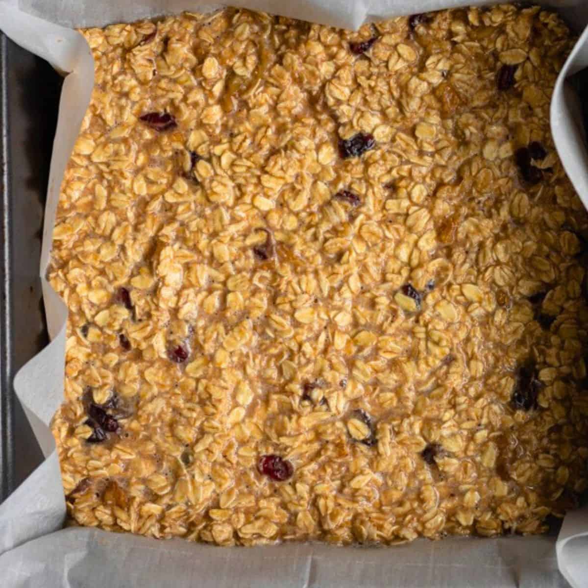 Oat bar mixture with add ins in a baking dish.
