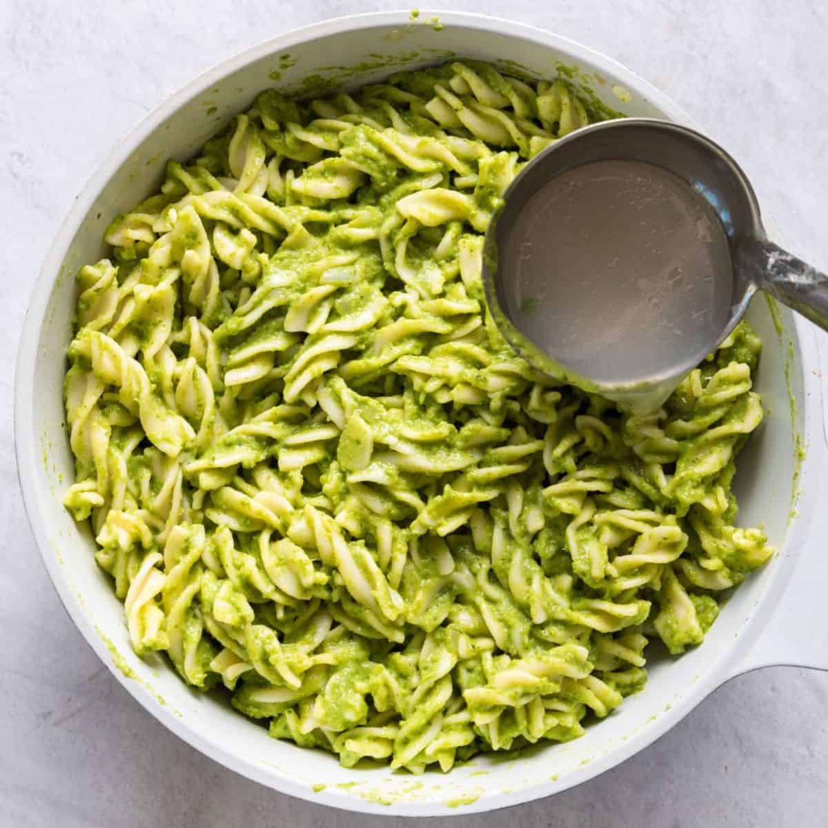 Adding extra pasta water to thin.