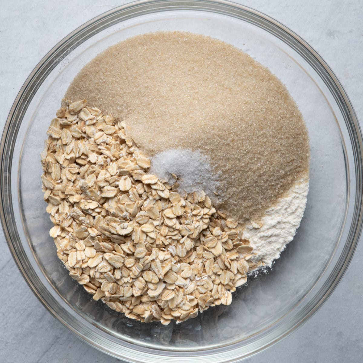 Bowl with oats, flour, brown sugar and salt.