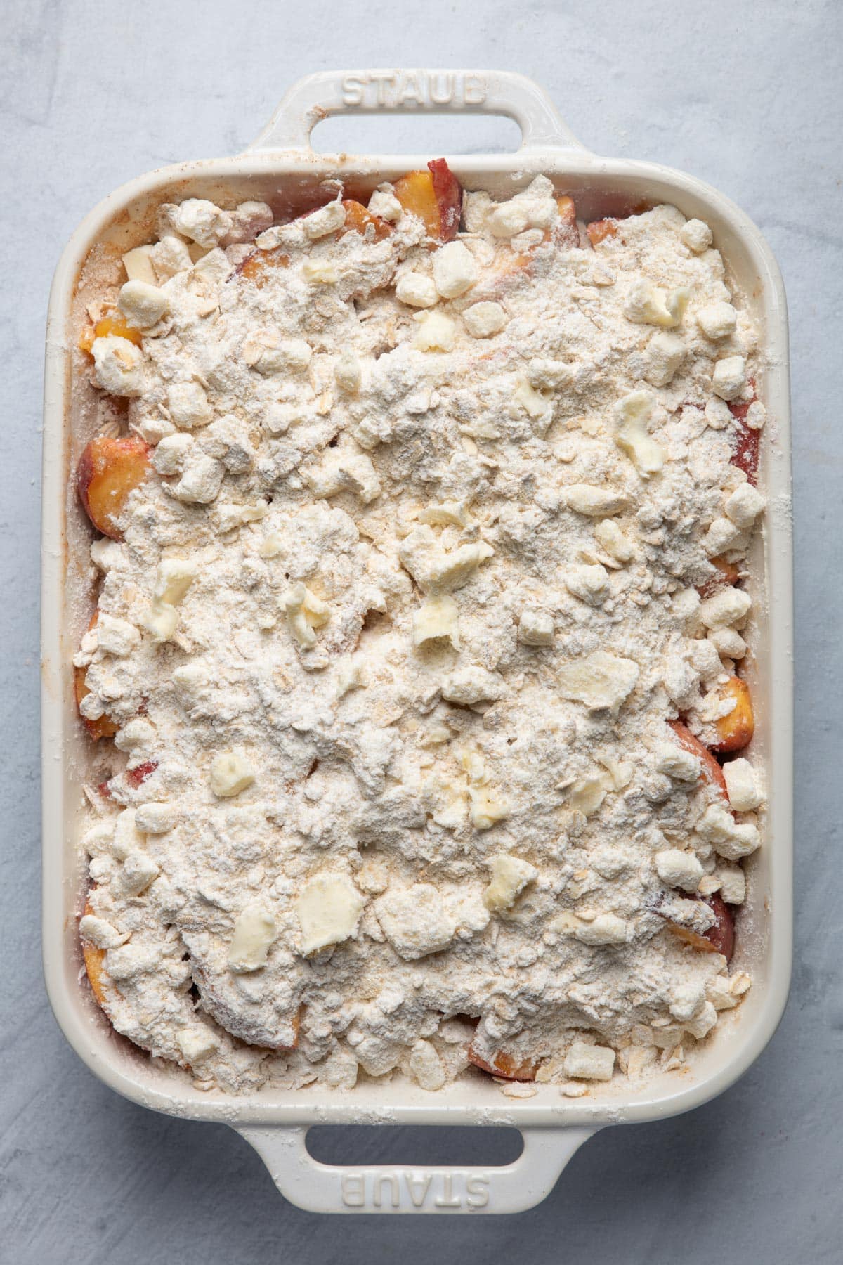 Baking dish with filling and crisp on top before baking.