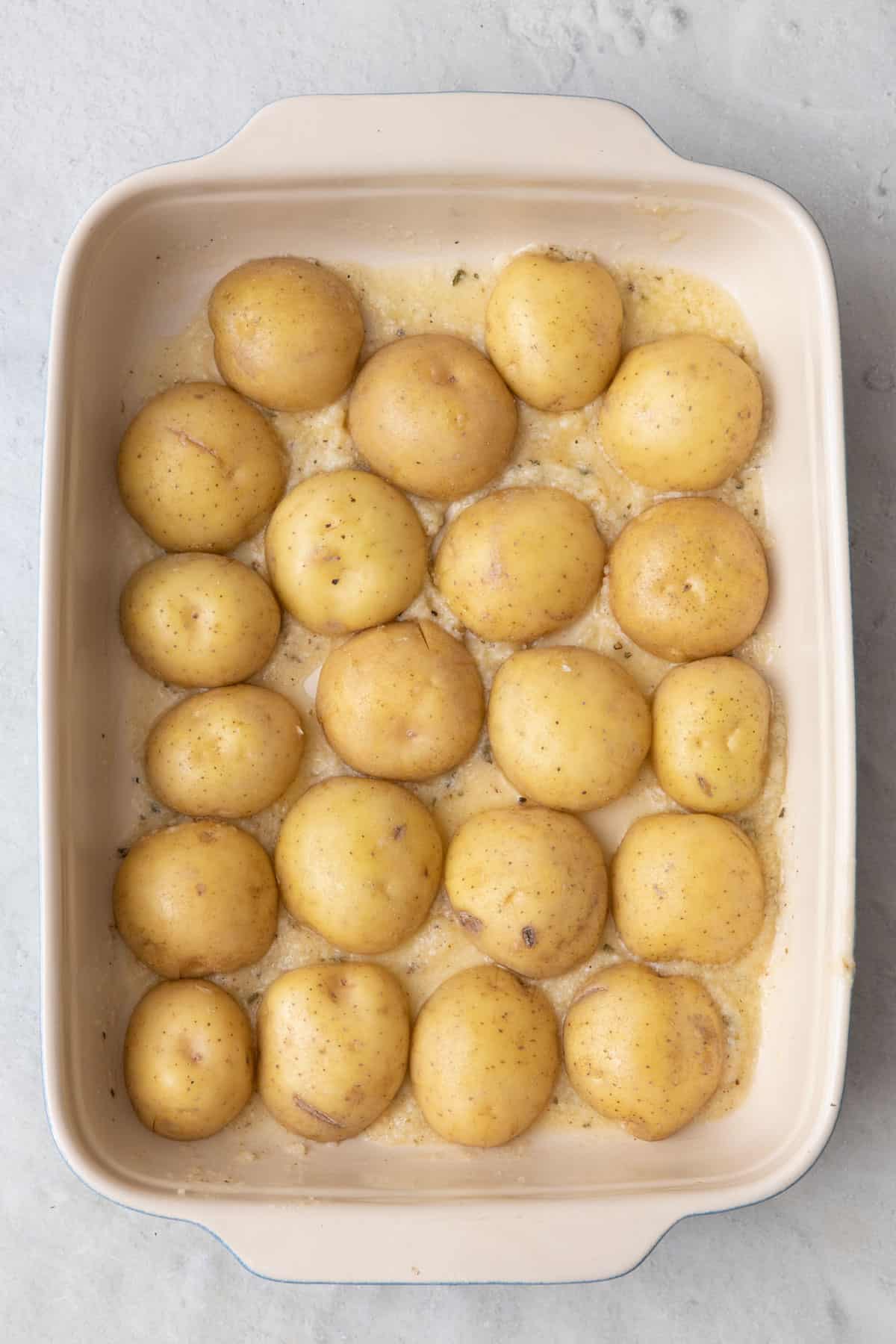 Halved potatoes cut side down pressed into butter cheese mixture.