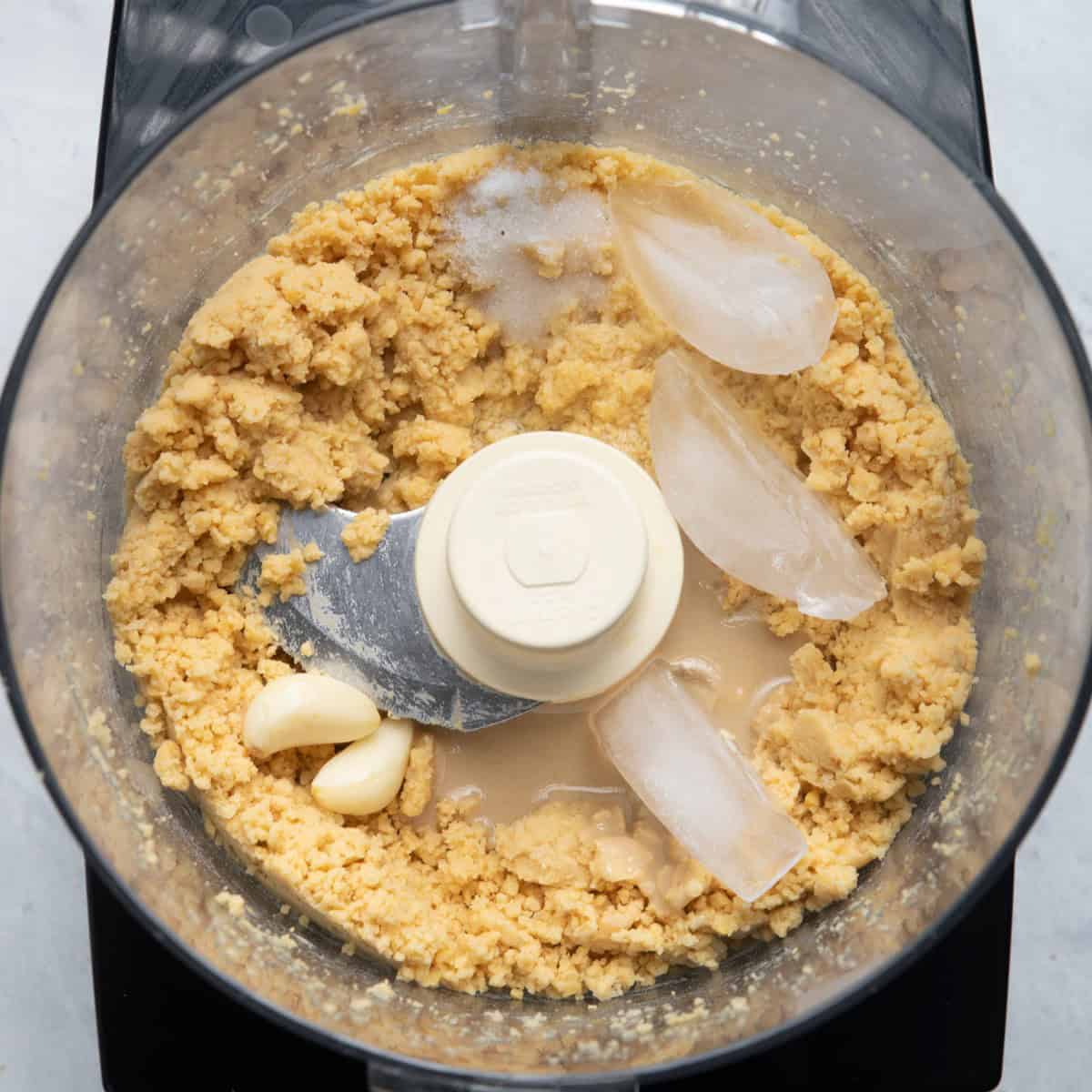 Tahini, ice, salt and garlic added.