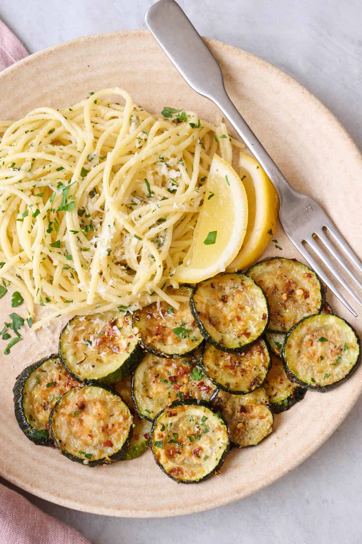 Easy roasted zucchini recipe on a plate with pasta.