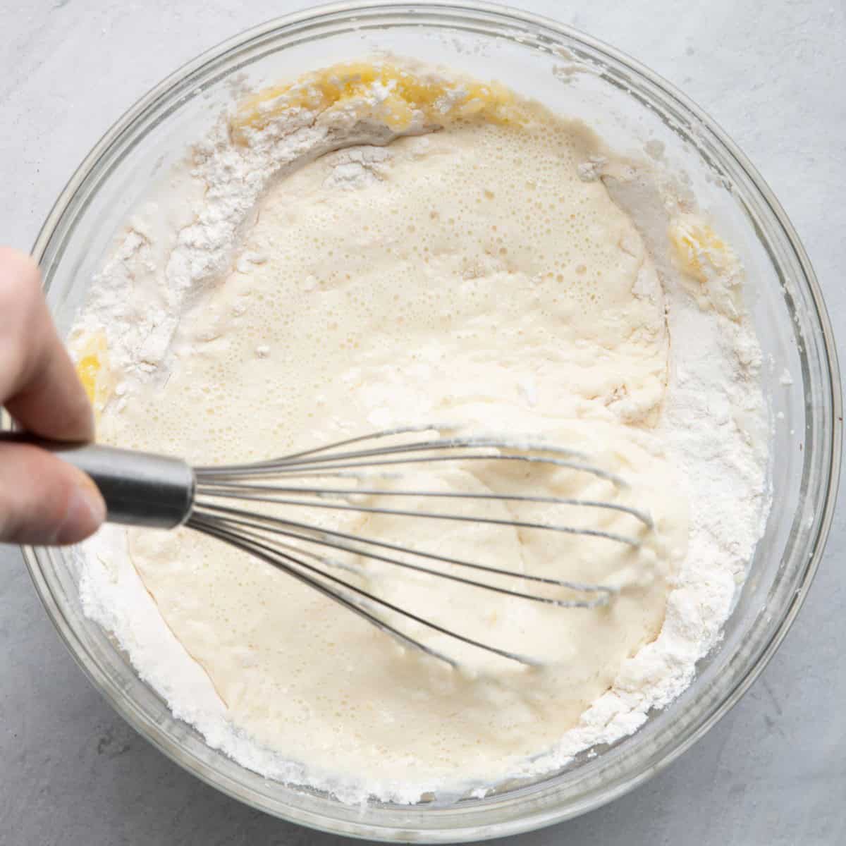 Whisking together wet and dry ingredients.