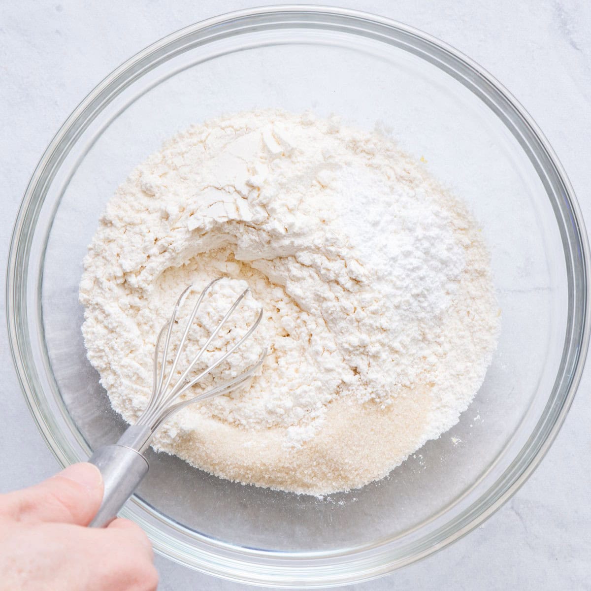 Whisking dry ingredients for recipe in a bowl.