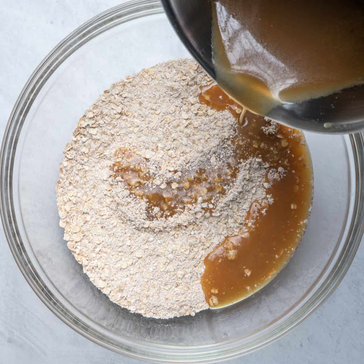 Adding butter sugar mixture to oat mixture.