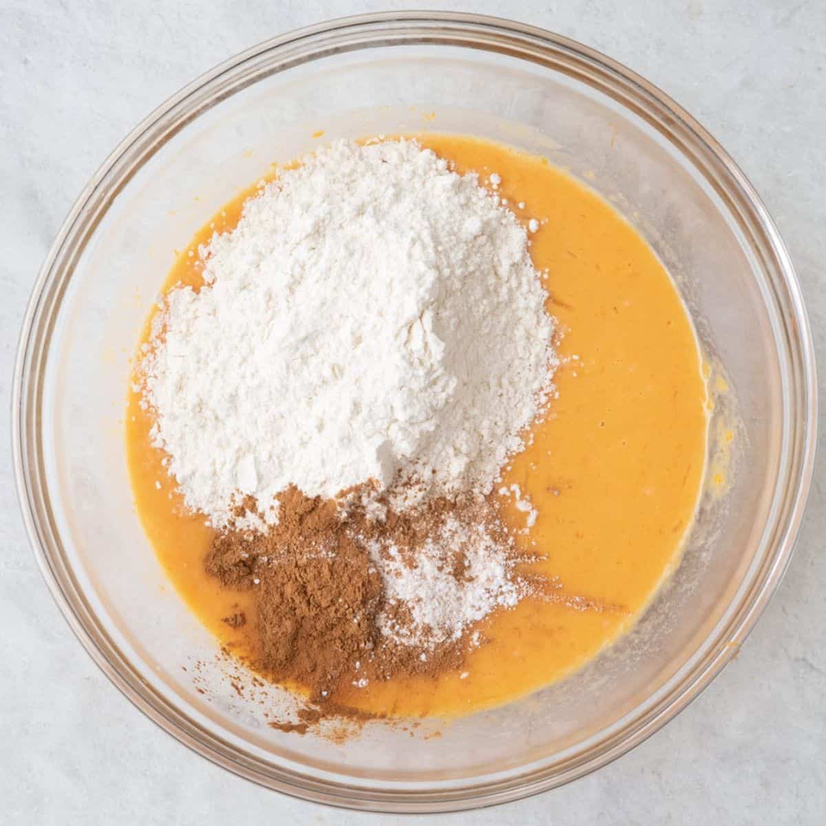 Dry ingredients added to wet mixture in bowl.