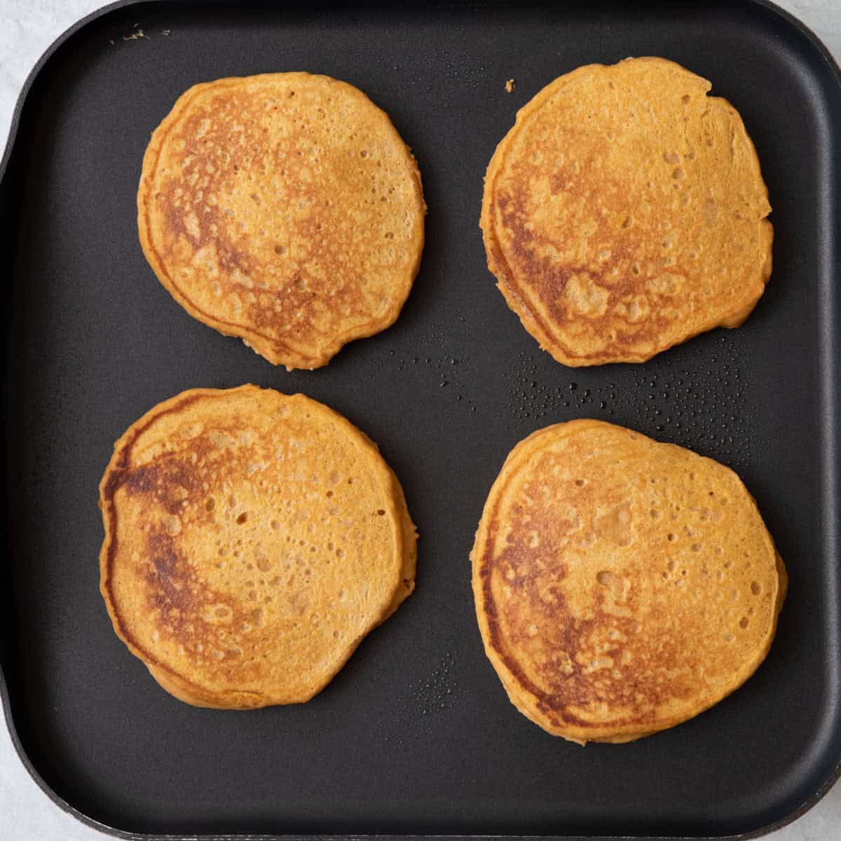 After flipping pancakes on griddle.