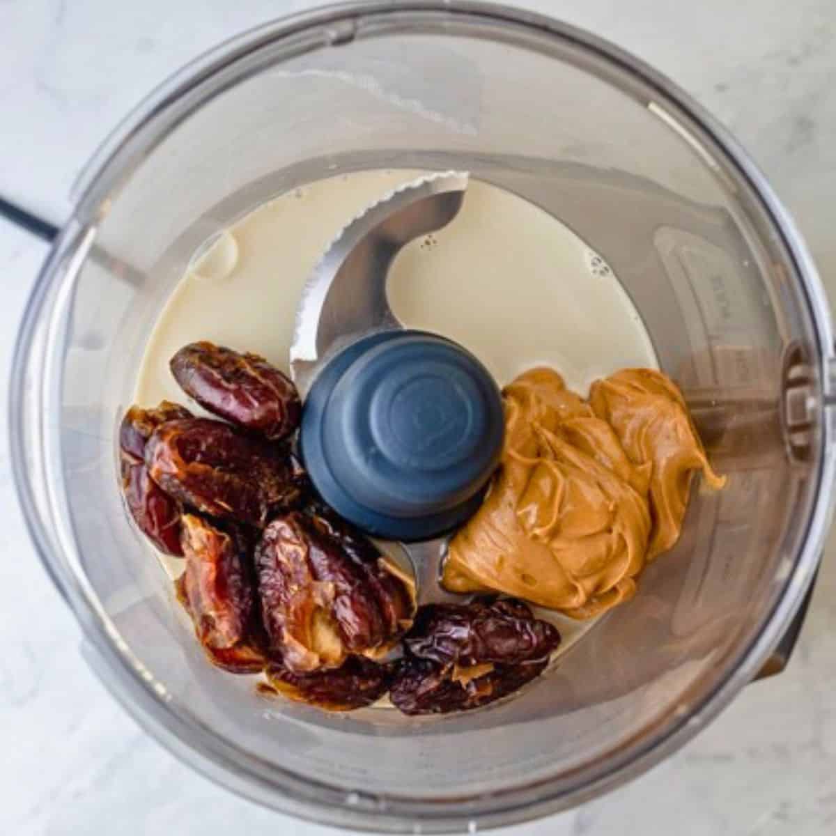 Peanut butter, dates, and almond milk in a food processor.