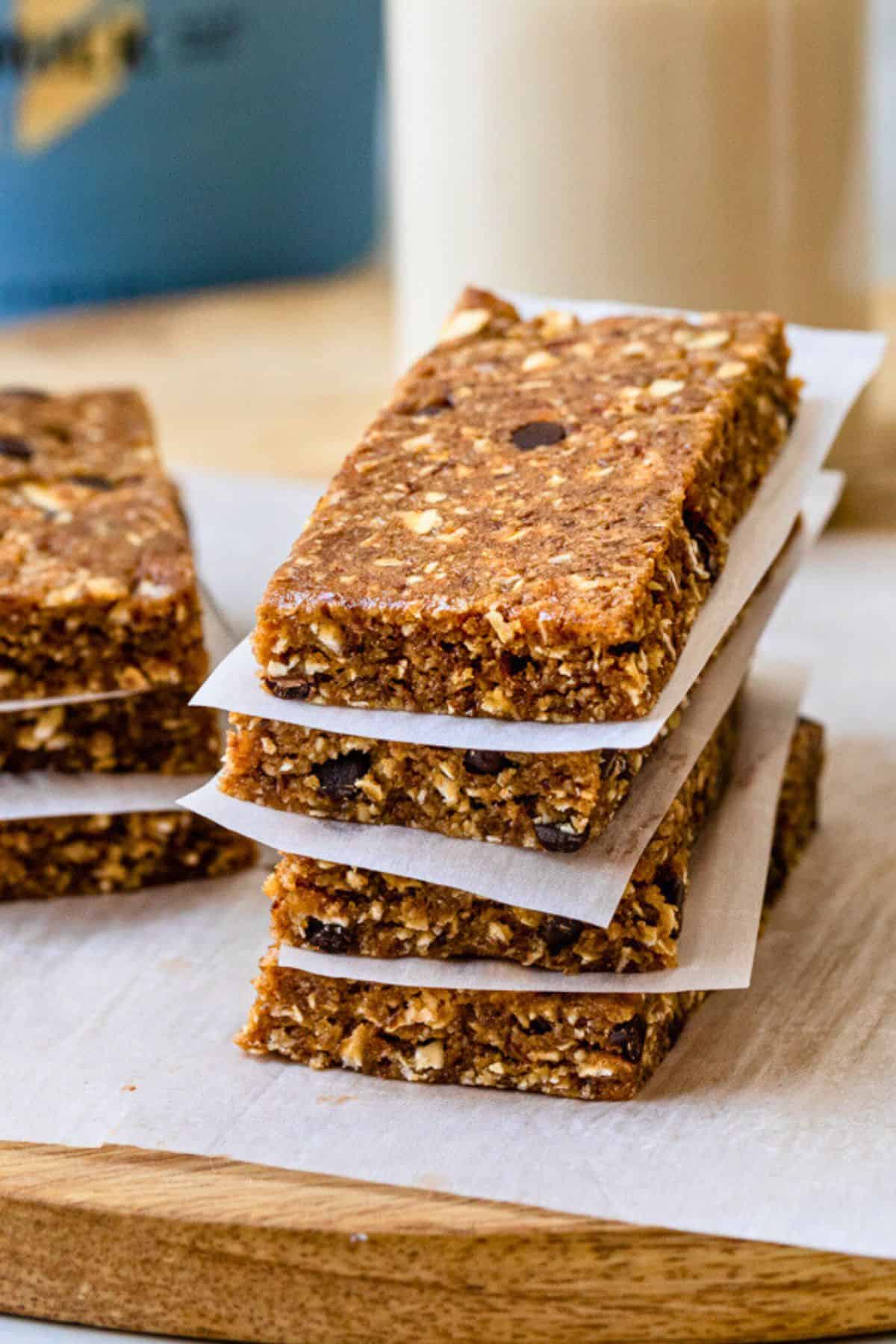 Vegan protein bars stacked up with parchment paper.