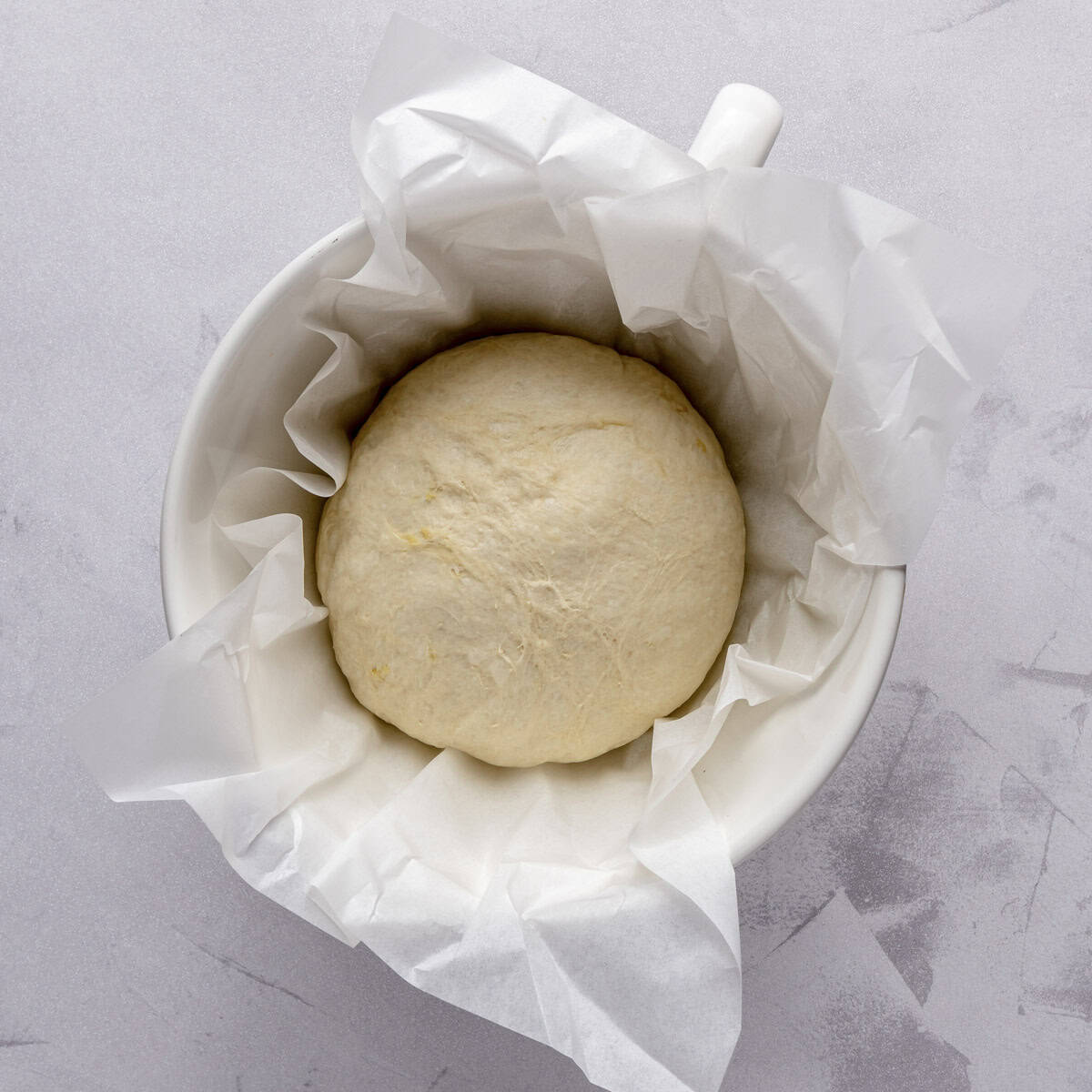 After forming the dough into a smooth dough ball placed in a large parchment lined bowl.