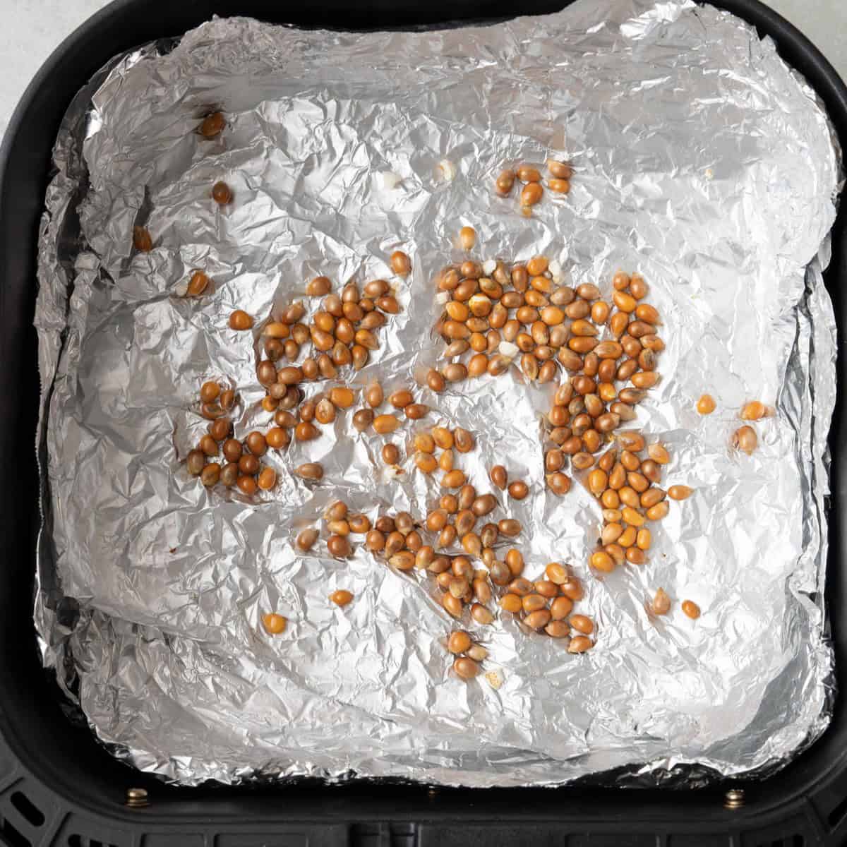 Showing some leftover unpopped ones in air fryer basket.