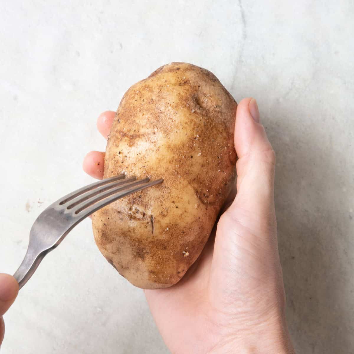 Fork piercing potato.