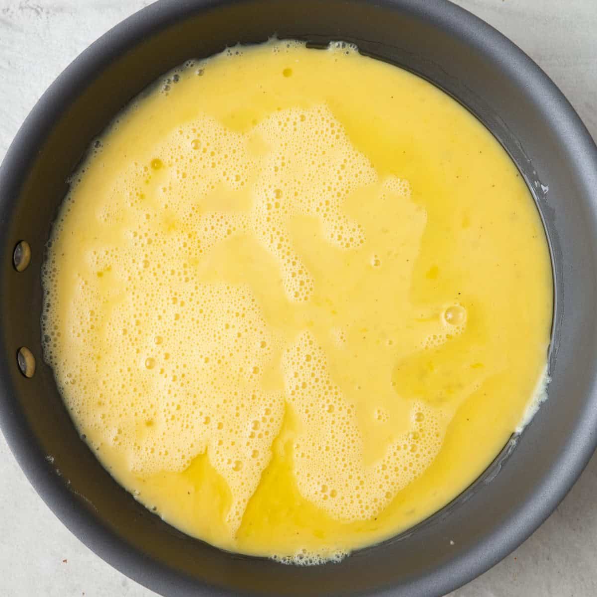 Egg mixture added to skillet.