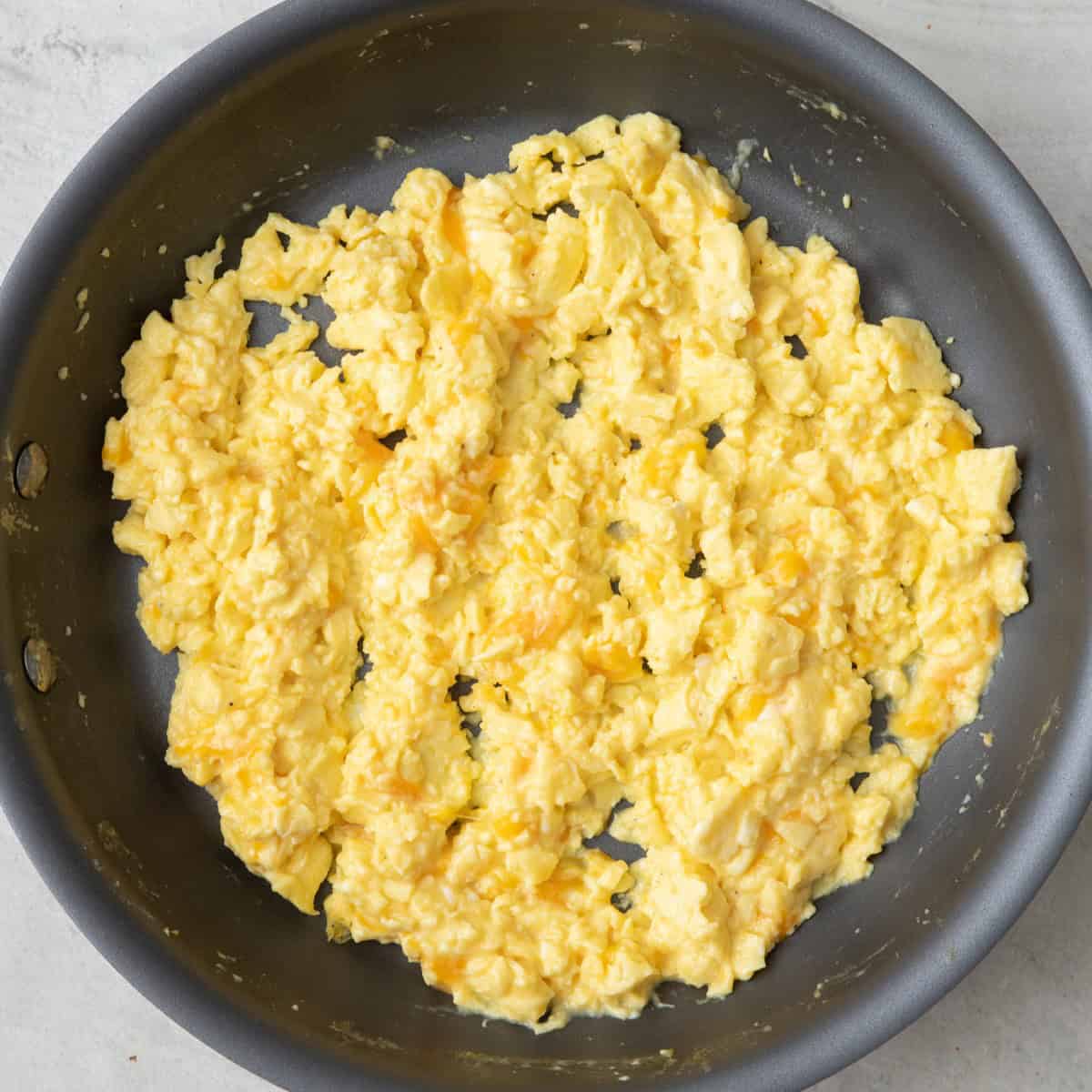 Eggs after cheese has been mixed in and melted.