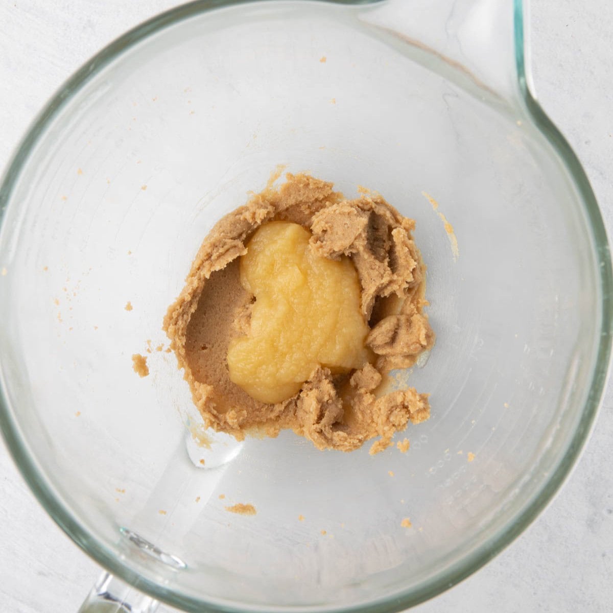 Butter and sugar creamed together with applesauce added before combined.