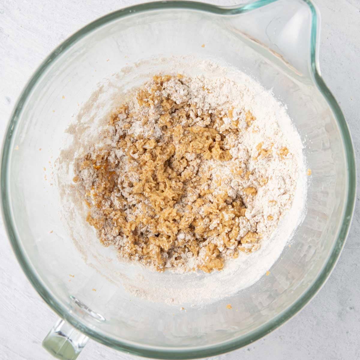 Egg and butter combined with flour mixture added, partially mixed in.
