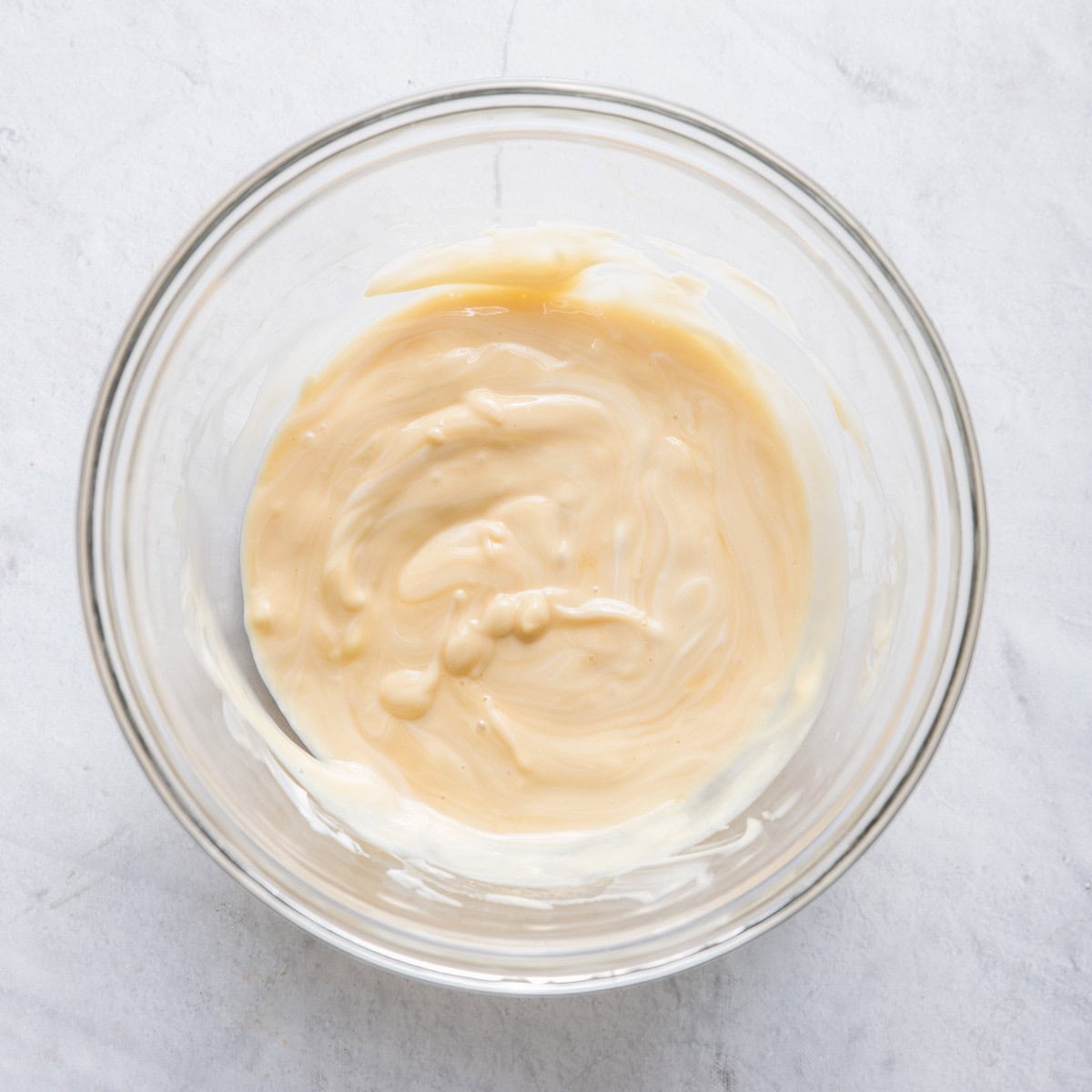 Yogur tand honey mixed in a bowl.